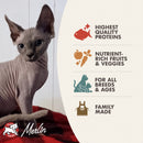 Cat with Merlin pet food packaging highlighting quality, nutrition, and family-made aspects.