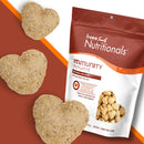 Heart-shaped dog treats with a Fromm Family Nutritionals package on a brown background