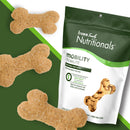 Dog treats shaped like bones with a 'fromm family nutritionals' package on a green background