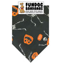 Dog bandana with Halloween designs on a black background, featuring skeletons, pumpkins, and the brand 'Fundog Bandanas'.
