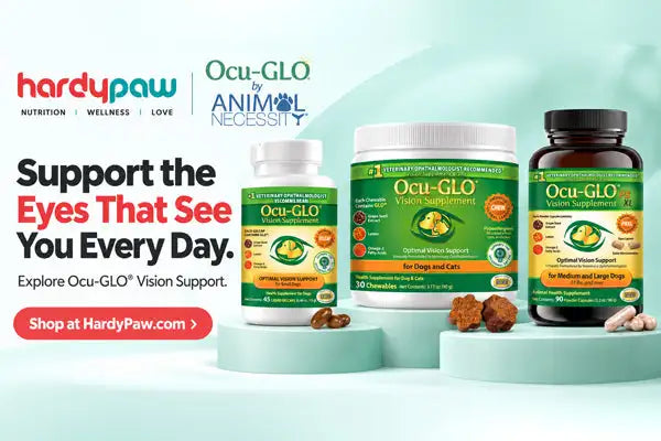 HardyPaw and Ocu-GLO by Animal Necessity vision support supplement products displayed on light teal pedestals against a pale mint background. The products include a small white bottle, a medium white jar, and a dark amber bottle, all with green and yellow labels.