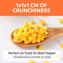 Wooden spoon filled with yellow cubes on a white background with text about crunchiness and size.