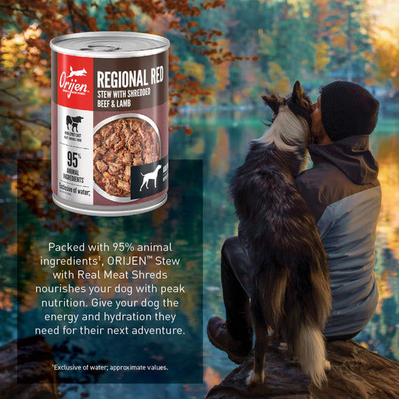 Orijen Regional Red stew can with a person and dog by a lake
