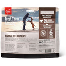 Orijen dog treats packaging with a person and dog on a beach