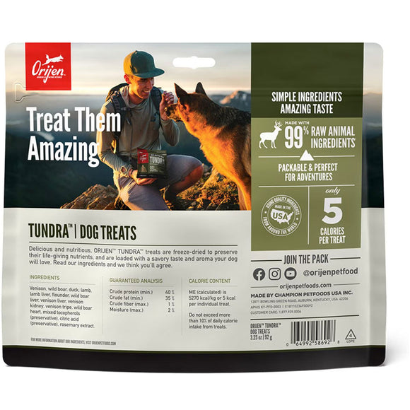 Orijen Tundra dog treats packaging with a person and dog on a mountain background