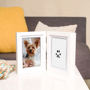 Open photo album with a picture of a dog and a paw print on a couch background
