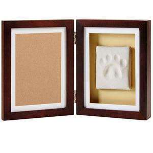Wooden frame with a white paw print inside on a beige background