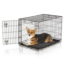 Dog inside a black metal crate on a white background