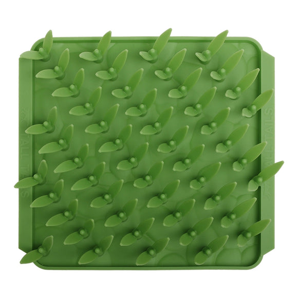 Green silicone mat with textured surface on a white background