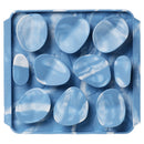 Blue marbled stones in a clear plastic tray on a white background