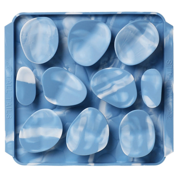 Blue marbled stones in a clear plastic tray on a white background