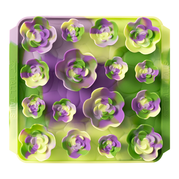 Silicone mold with flower-shaped cavities in green and purple on a white background