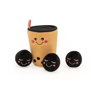 Toy resembling a coffee cup with three black characters on a white background