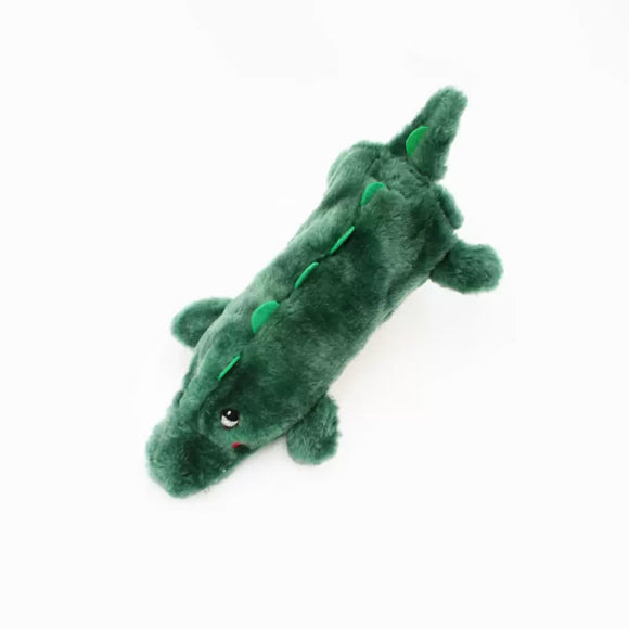 Green plush alligator toy on a white background
