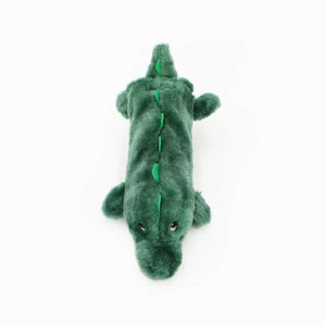 Green plush alligator toy on a white background