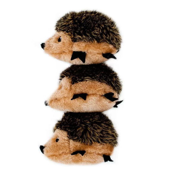Stack of three plush hedgehogs on a white background