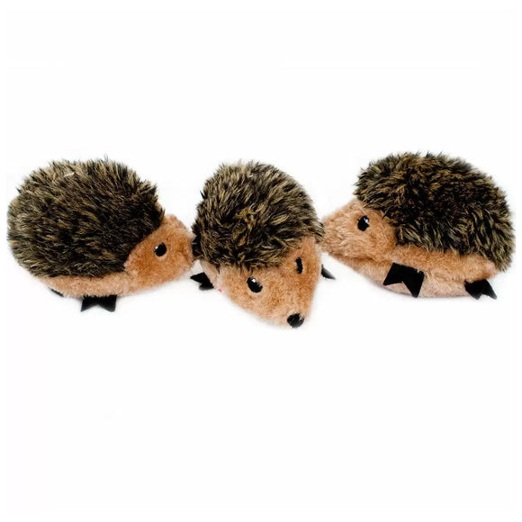 Three plush hedgehog toys on a white background