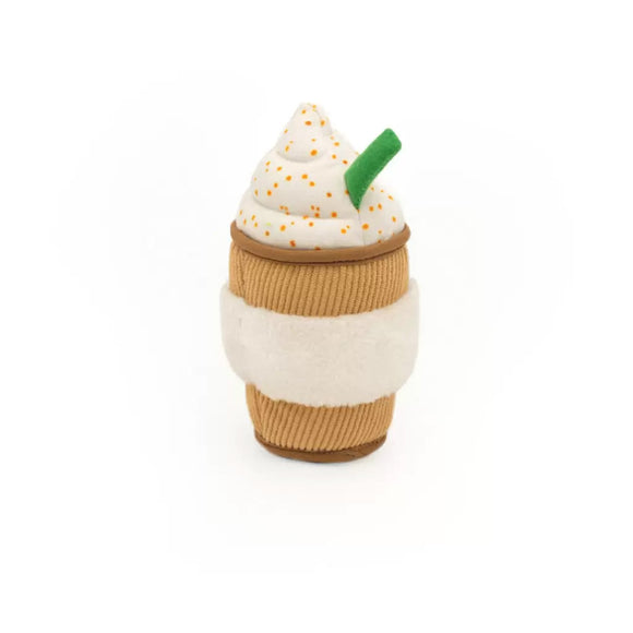Toy resembling a coffee cup with whipped cream and a green straw on a white background