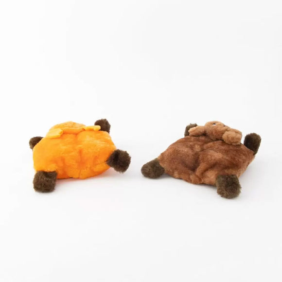 Two plush toys, one orange and one brown, on a white background