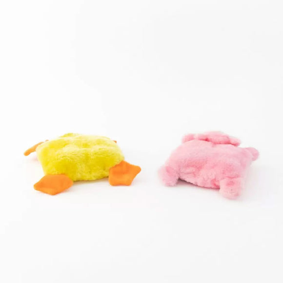 Two plush toys, one yellow and orange, the other pink, on a white background.